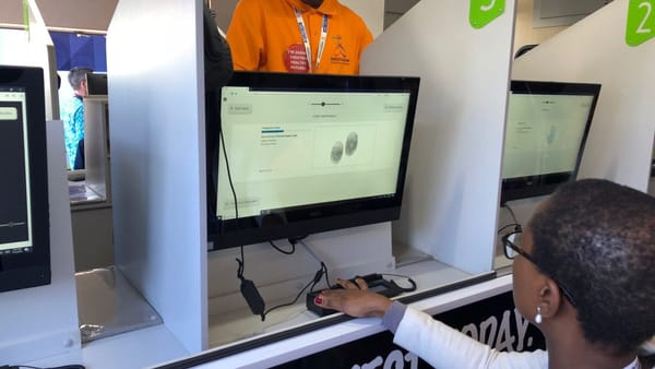 Shout It Now technician enrolling a client with an Integrated Biometrics fingerprint scanner
