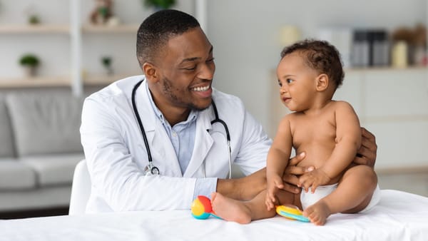 Doctor holding a young child, illustrating infant identification