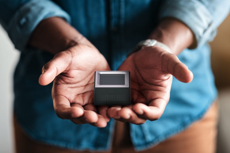Watson fingerprint scanner resting in open hands